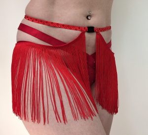 Close-up of a body wearing a red Burlesque shimmy belt with long fringing and a quick release clasp