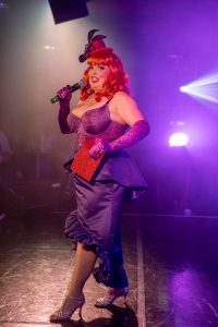 Lili Del Fflur wearing a bespoke purple satin mermaid skirt with pelmet